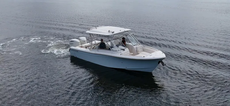Slide: The Image of A 2027 Grady-White Freedom 285 boat cruising on calm waters. - 3