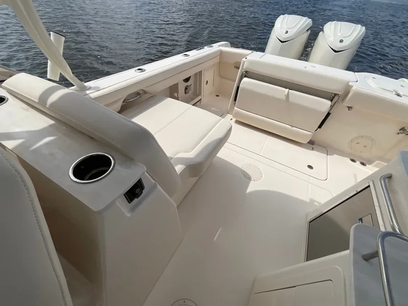 Slide: The Image of The image shows the cockpit of a Grady-White Freedom 285 boat with beige seating and two outboard engines. - 6