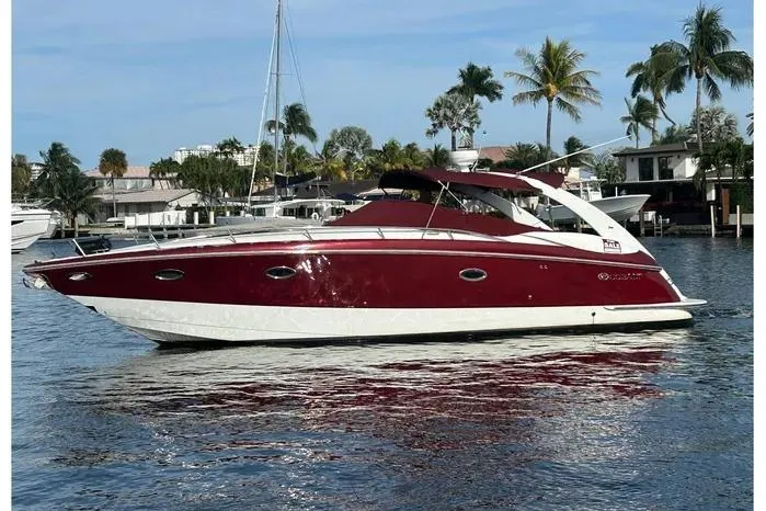 The Image of 2005 Cobalt 360 Cruiser in a scenic waterfront setting with palm trees. - 0