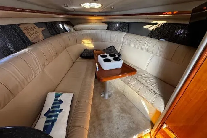 Slide: The Image of Luxurious interior of a 2005 Cobalt 360 Cruiser with beige seating and wooden table. - 12