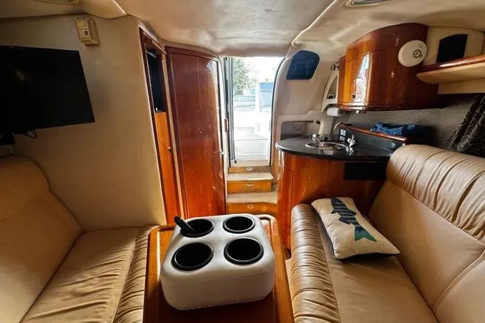 Slide: The Image of Interior of a 2005 Cobalt 360 Cruiser with leather seating and wooden cabinetry. - 14