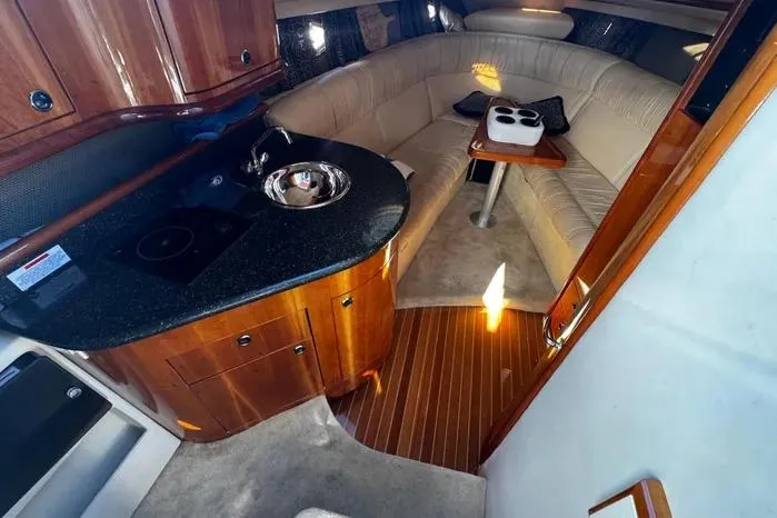 Slide: The Image of Interior of a 2005 Cobalt 360 Cruiser with kitchenette and cozy seating area. - 15