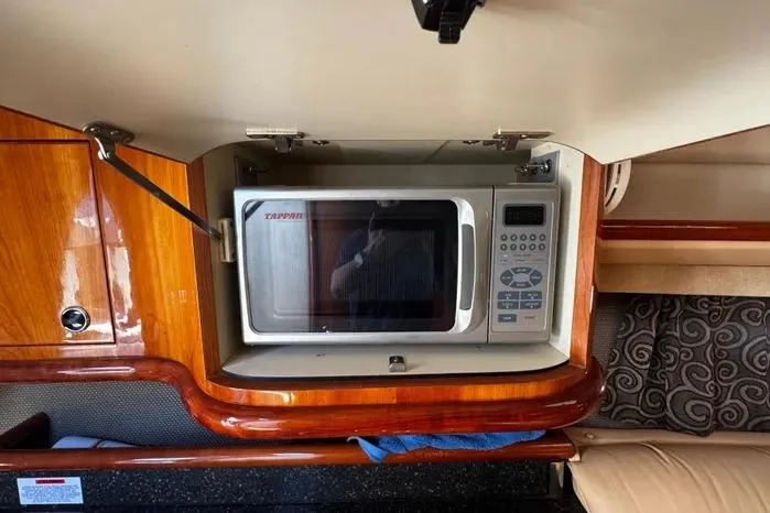 Slide: The Image of Microwave in 2005 Cobalt 360 Cruiser's wooden interior kitchen area. - 17
