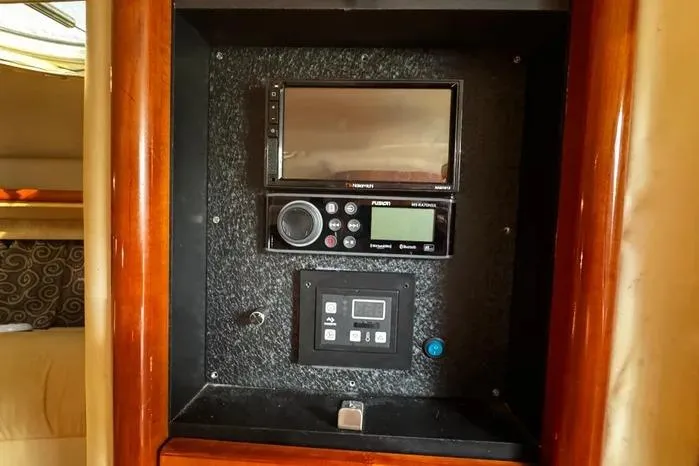 Slide: The Image of Control panel inside a 2005 Cobalt 360 Cruiser, featuring navigation and audio systems. - 19