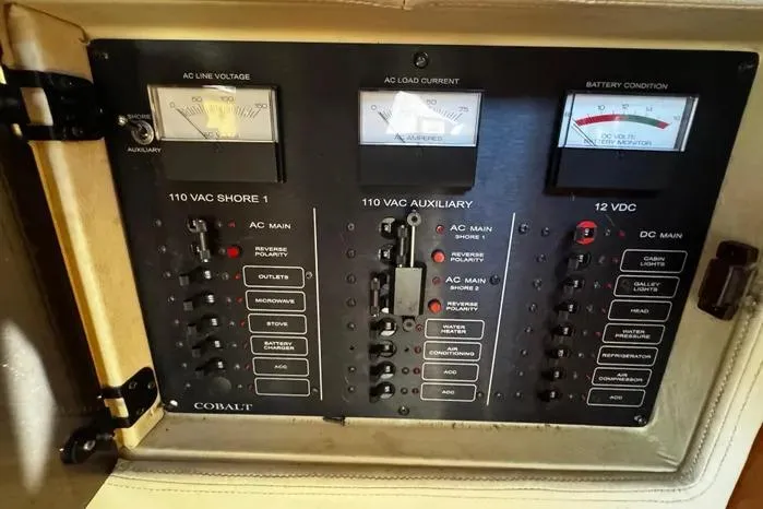 Slide: The Image of Electrical control panel of a 2005 Cobalt 360 Cruiser with voltage and current meters. - 20