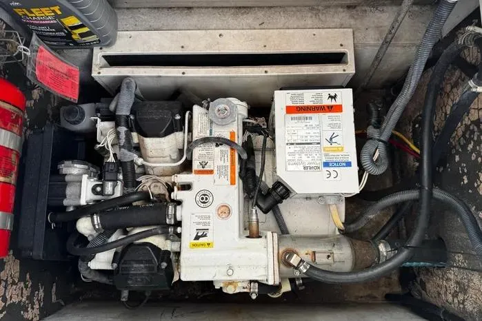 Slide: The Image of Engine compartment of a 2005 Cobalt 360 Cruiser with visible wiring and components. - 24