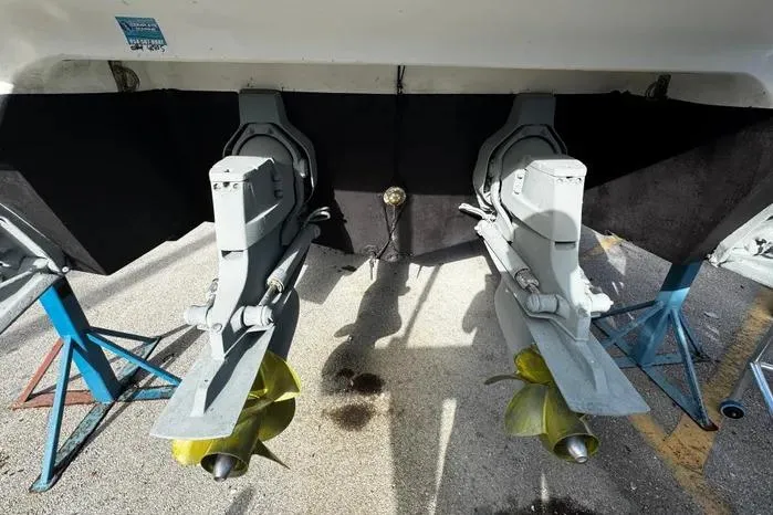Slide: The Image of 2005 Cobalt 360 Cruiser dual propellers on stands, viewed from the rear. - 25