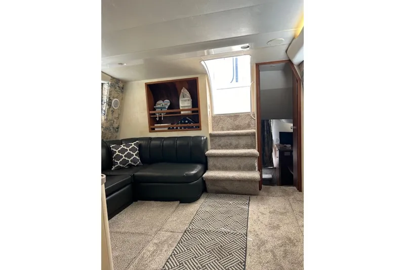 Slide: The Image of Interior of 1996 Silverton 442 Cockpit Motor Yacht with plush seating and carpeted stairs. - 14