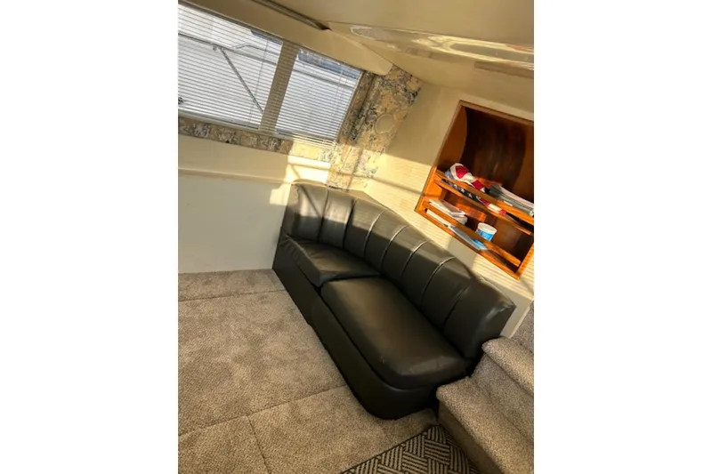 Slide: The Image of Interior of 1996 Silverton 442 Cockpit Motor Yacht with leather sofa and carpeted floor. - 15