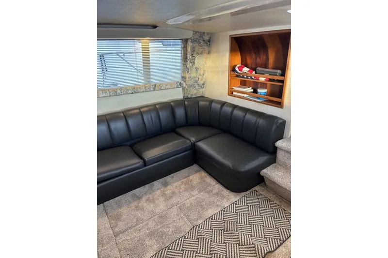 Slide: The Image of Luxurious interior of 1996 Silverton 442 Cockpit Motor Yacht with black leather seating. - 16