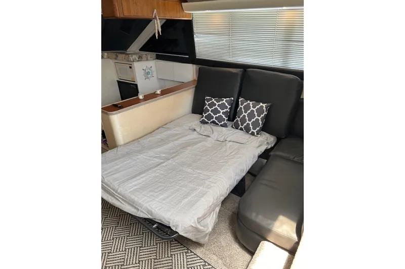 Slide: The Image of Interior of 1996 Silverton 442 Cockpit Motor Yacht with convertible sofa bed. - 17