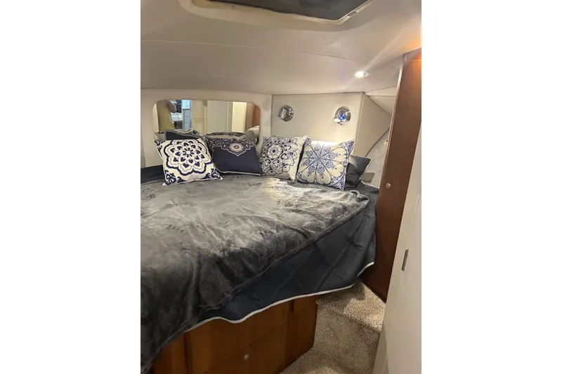 Slide: The Image of Luxurious bedroom interior of 1996 Silverton 442 Cockpit Motor Yacht with plush bedding. - 20