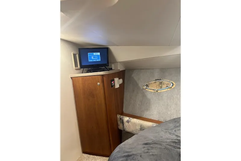 Slide: The Image of Interior of 1996 Silverton 442 Cockpit Motor Yacht with TV and wooden cabinet. - 21
