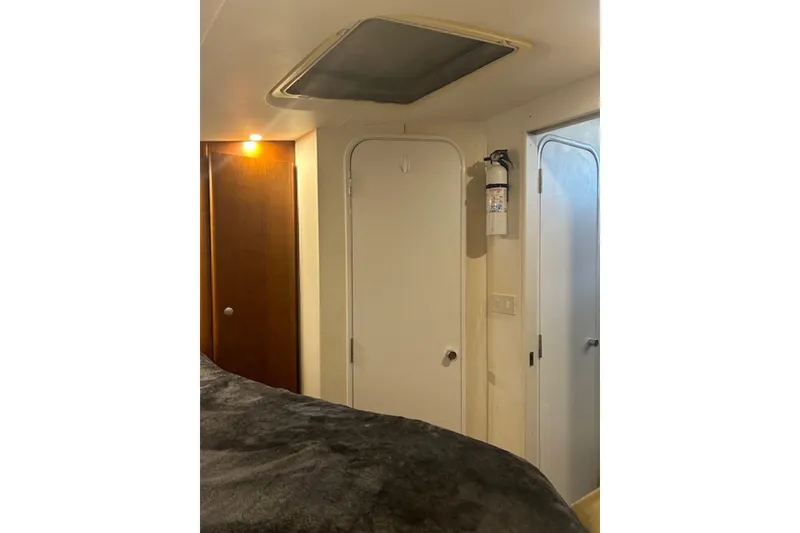 Slide: The Image of Interior of 1996 Silverton 442 Cockpit Motor Yacht with doors and fire extinguisher. - 22