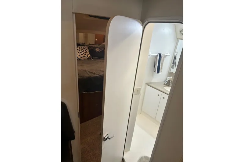 Slide: The Image of Interior view of 1996 Silverton 442 Cockpit Motor Yacht showing bedroom and bathroom. - 23