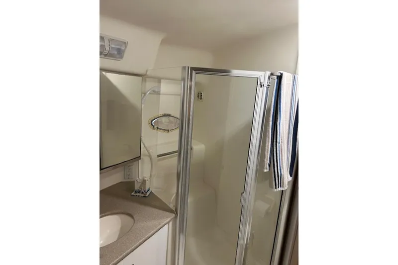 Slide: The Image of Bathroom interior of 1996 Silverton 442 Cockpit Motor Yacht with shower and mirror. - 24