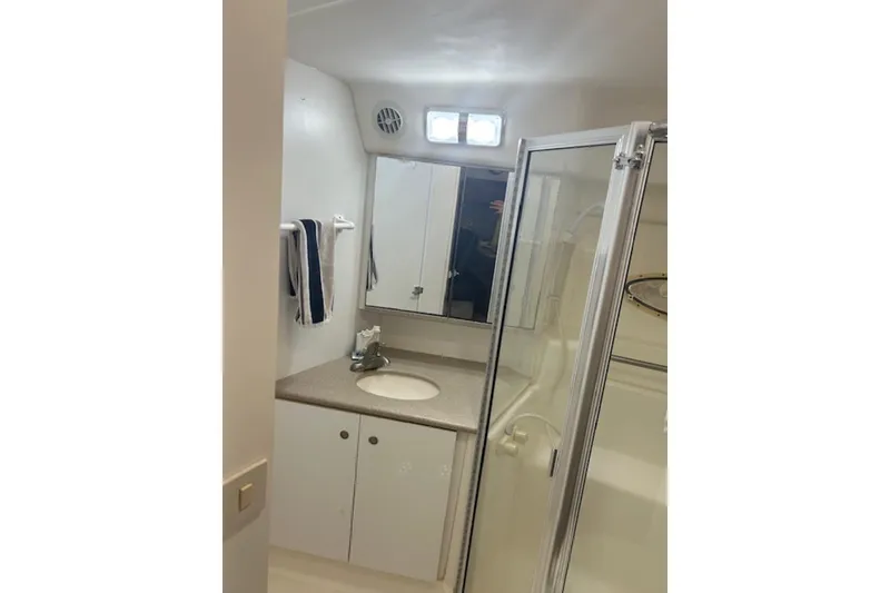 Slide: The Image of Bathroom interior of 1996 Silverton 442 Cockpit Motor Yacht with shower and vanity. - 25