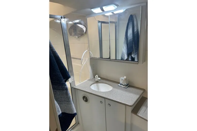 Slide: The Image of Bathroom interior of 1996 Silverton 442 Cockpit Motor Yacht with sink and mirror cabinet. - 26