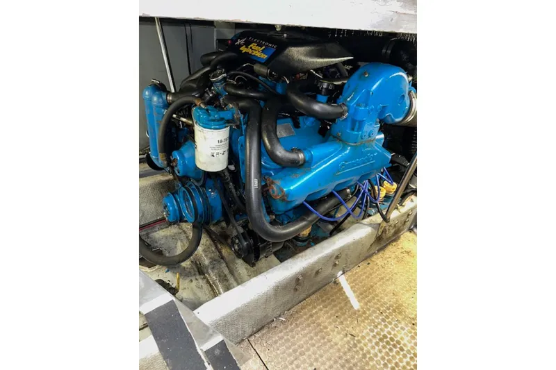 Slide: The Image of Engine of 1996 Silverton 442 Cockpit Motor Yacht, featuring blue components and wiring. - 28