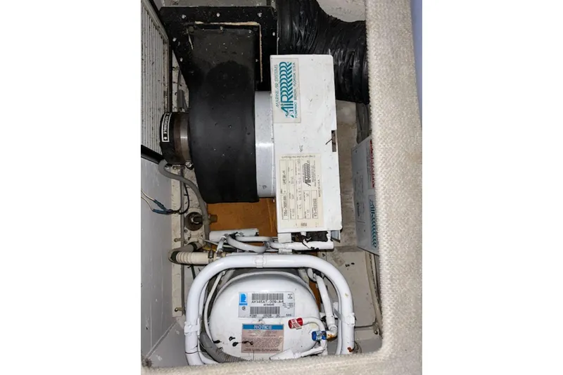 Slide: The Image of Engine compartment of 1996 Silverton 442 Cockpit Motor Yacht with visible components. - 31