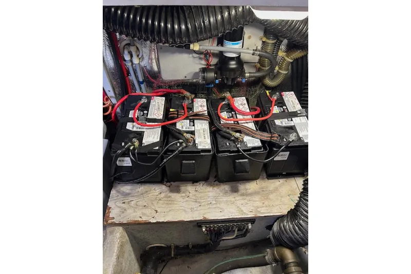 Slide: The Image of Battery compartment of a 1996 Silverton 442 Cockpit Motor Yacht with wiring and hoses. - 37