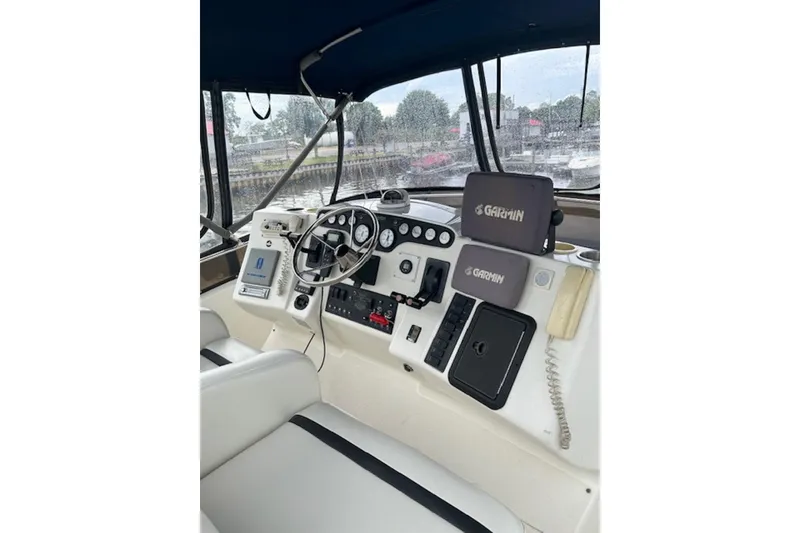 Slide: The Image of 1996 Silverton 442 Cockpit Motor Yacht helm with Garmin navigation and control panel. - 8