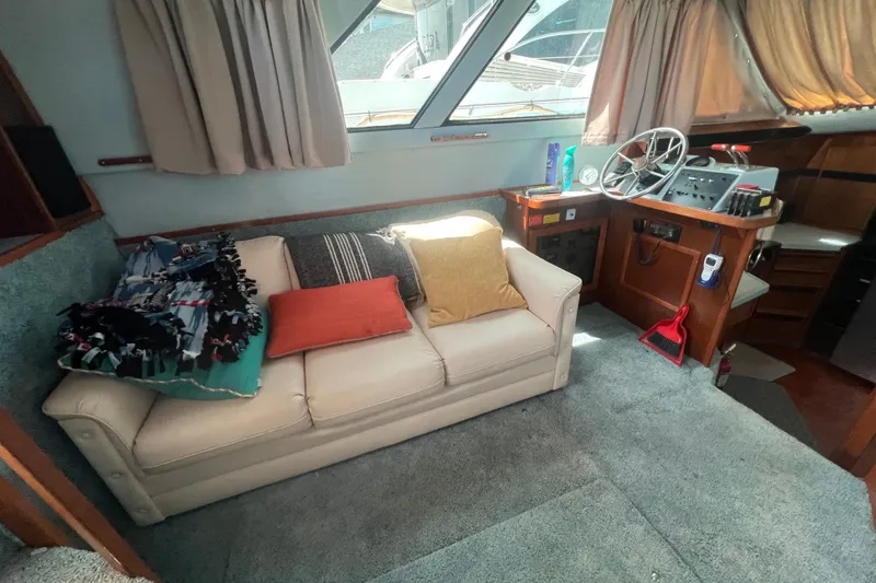 Slide: The Image of Interior of 1987 Sea Ray 410 Aft Cabin with sofa and helm station. - 10