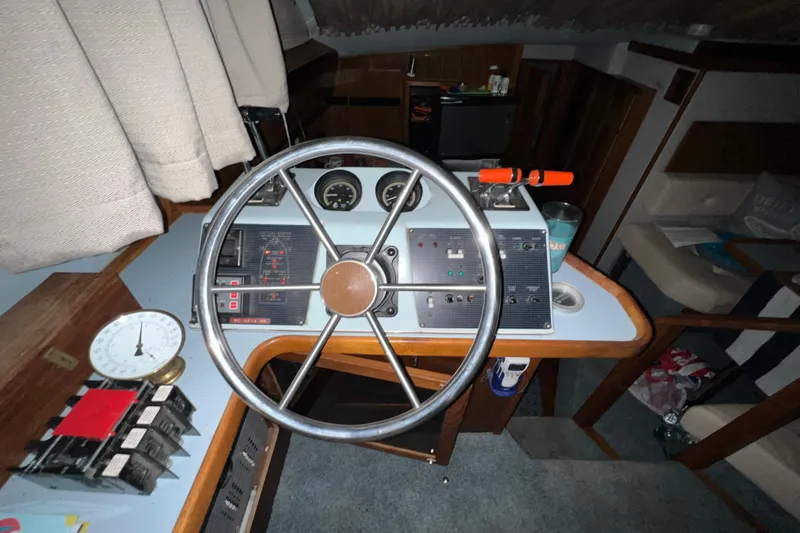 Slide: The Image of 1987 Sea Ray 410 Aft Cabin helm with steering wheel and control panel. - 11