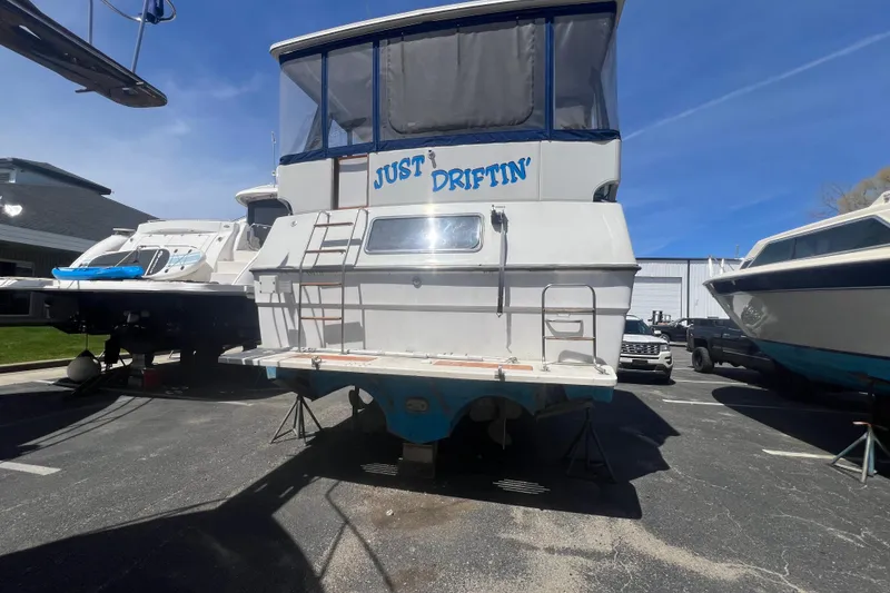 Slide: The Image of 1987 Sea Ray 410 Aft Cabin boat named "Just Driftin'" on dry dock. - 2