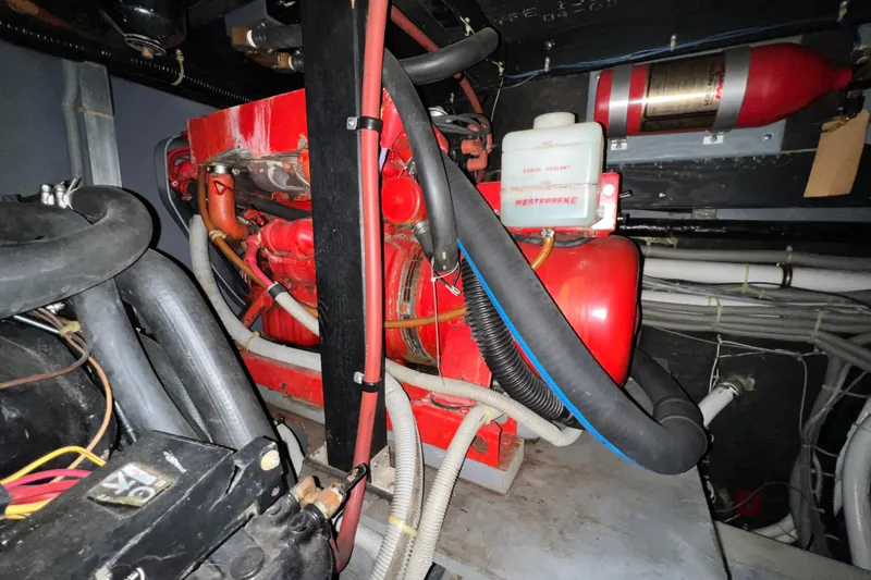 Slide: The Image of Engine compartment of 1987 Sea Ray 410 Aft Cabin with Westerbeke generator and fire extinguisher. - 24