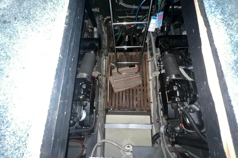 Slide: The Image of Engine room of 1987 Sea Ray 410 Aft Cabin with visible mechanical components. - 25