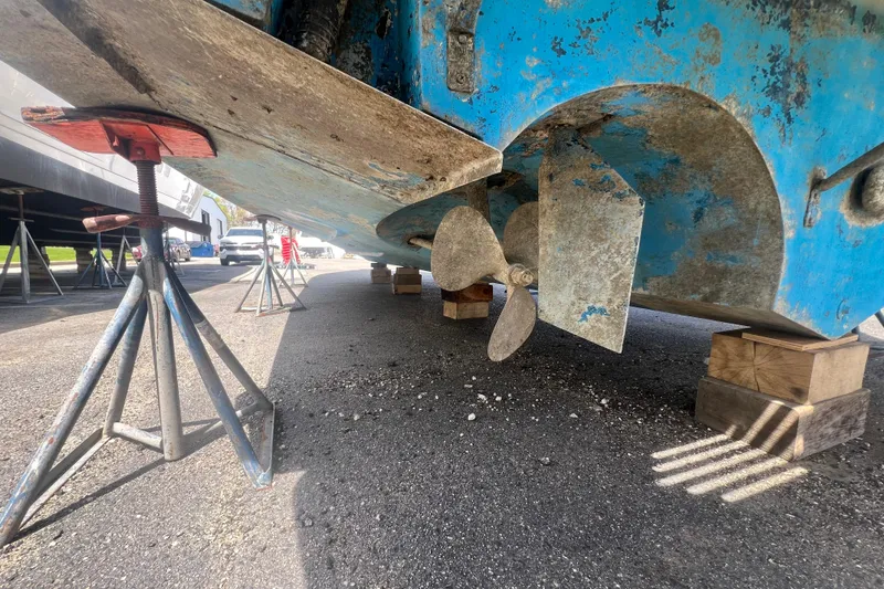 Slide: The Image of 1987 Sea Ray 410 Aft Cabin boat propeller and rudder on dry dock stands. - 26