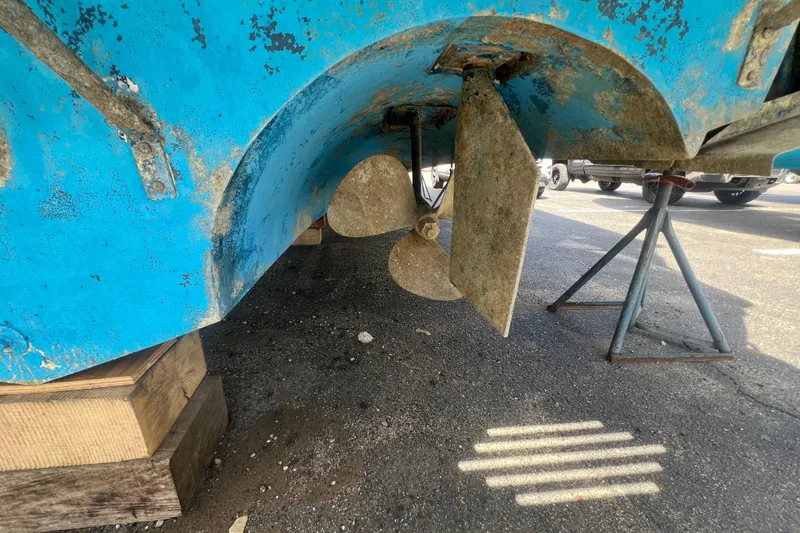 Slide: The Image of 1987 Sea Ray 410 Aft Cabin boat propeller and rudder on dry dock. - 28