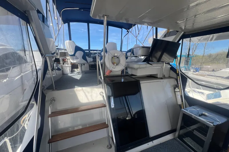 Slide: The Image of 1987 Sea Ray 410 Aft Cabin interior with helm, seating, and navigation equipment. - 5