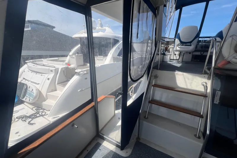 Slide: The Image of 1987 Sea Ray 410 Aft Cabin interior with stairs and seating area. - 6