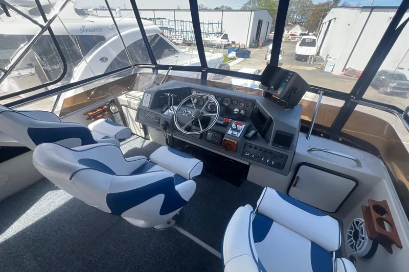Slide: The Image of Cockpit of 1987 Sea Ray 410 Aft Cabin yacht with modern controls and seating. - 7