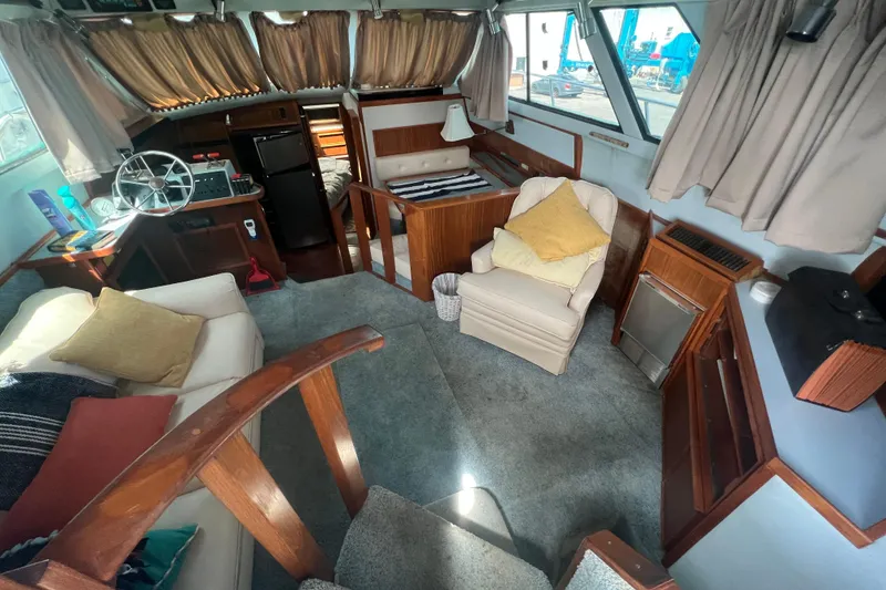 Slide: The Image of Interior of 1987 Sea Ray 410 Aft Cabin yacht with cozy seating and helm station. - 9