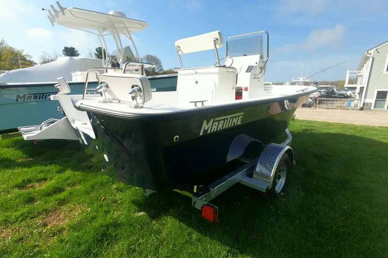 Slide: The Image of 2026 Maritime 189 Defiant boat on trailer, parked on grass under clear sky. - 15