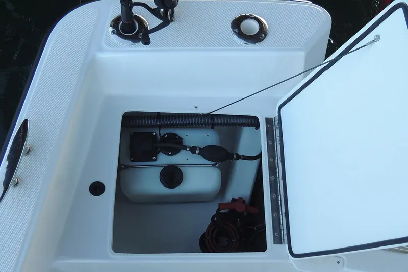 Slide: The Image of Manufacturer Provided Image: Open storage compartment on a 2026 Maritime 189 Defiant boat. - 2