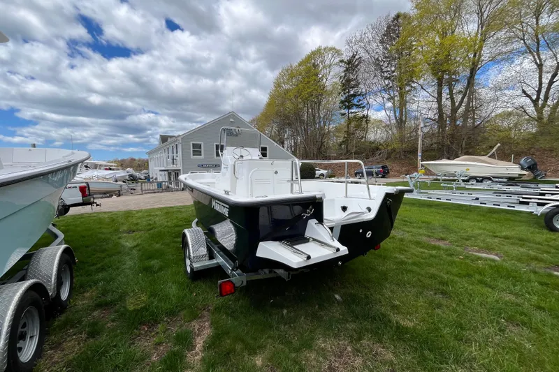 Slide: The Image of 2026 Maritime 189 Defiant boat on trailer, grassy area, cloudy sky background. - 3