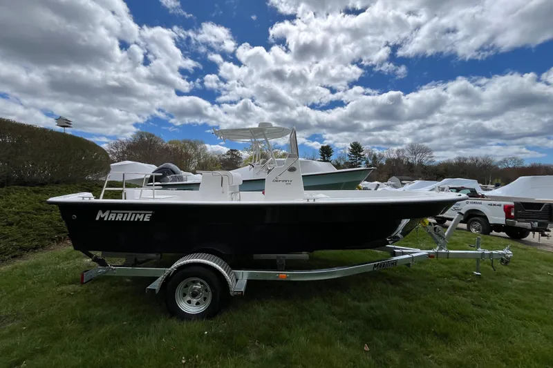 Slide: The Image of 2026 Maritime 189 Defiant boat on trailer under cloudy sky. - 4