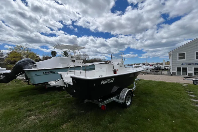 Slide: The Image of 2026 Maritime 189 Defiant boat on trailer, parked on grass under cloudy sky. - 5