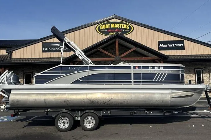 The Image of 2022 Bennington 22 L pontoon boat on trailer at Boat Masters dealership. - 1