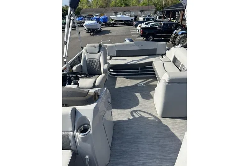 Slide: The Image of 2022 Bennington 22 L pontoon boat interior with plush seating and modern design. - 11