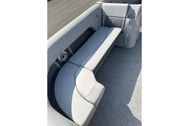 Slide: The Image of 2022 Bennington 22 L boat interior with gray seating and speaker detail. - 12