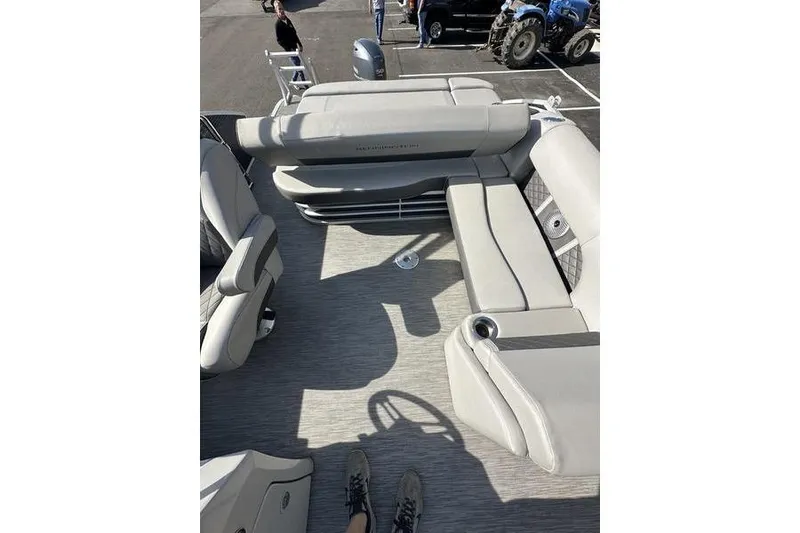 Slide: The Image of 2022 Bennington 22 L pontoon boat interior with beige seating and flooring. - 13