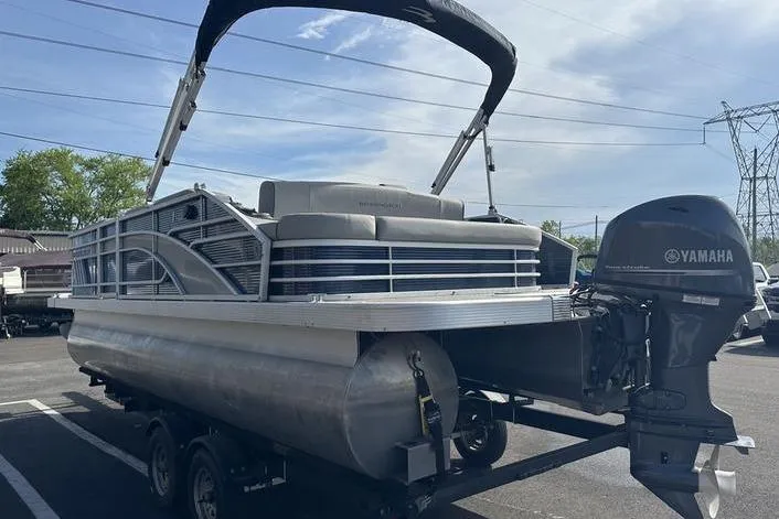 Slide: The Image of 2022 Bennington 22 L pontoon boat with Yamaha outboard motor in a parking lot. - 18