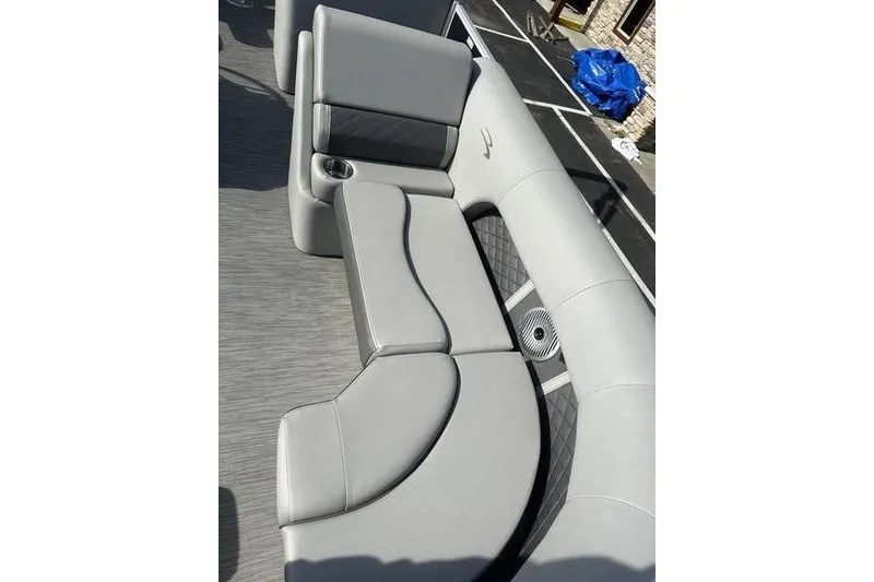 Slide: The Image of 2022 Bennington 22 L boat interior with gray seating and cup holder. - 3