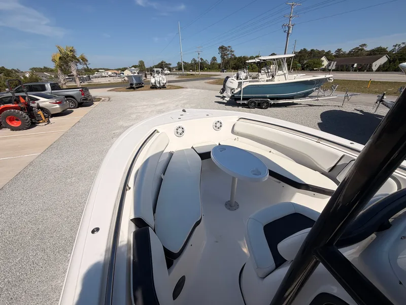 Slide: The Image of 2022 Tidewater 220 LXF boat with seating area and outdoor table. - 8