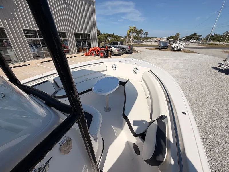 Slide: The Image of 2022 Tidewater 220 LXF boat with seating area and outdoor table. - 9